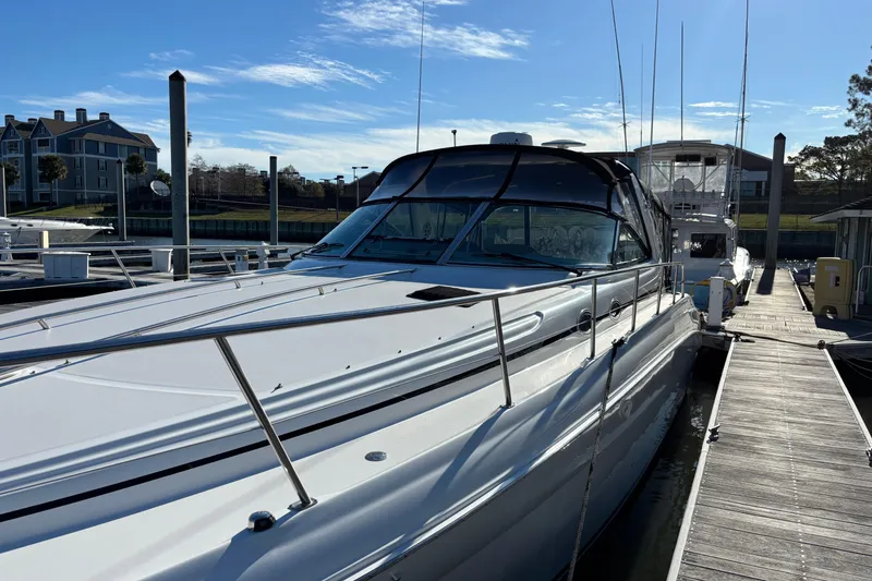 Slide: The Image of 1999 Sea Ray 380 Sundancer docked at marina under clear blue sky. - 4