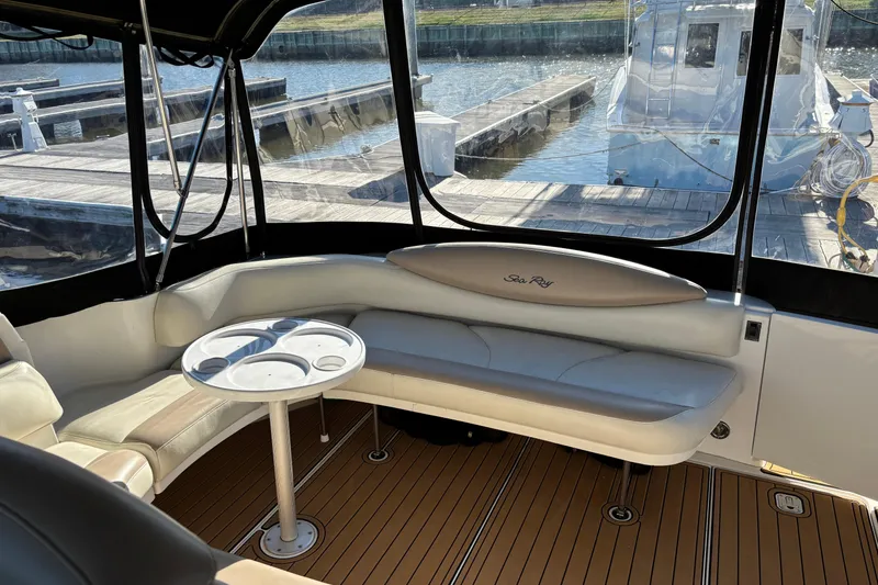 Slide: The Image of Interior of 1999 Sea Ray 380 Sundancer yacht with seating and table, docked at marina. - 5