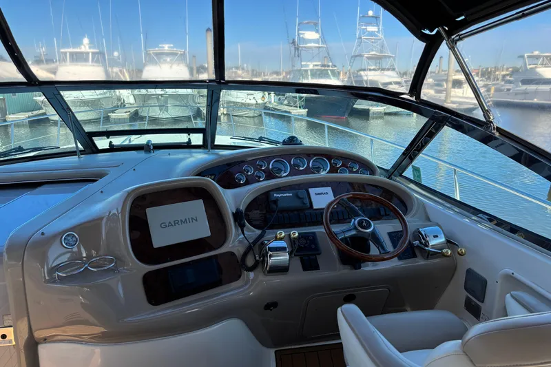 Slide: The Image of Cockpit view of 1999 Sea Ray 380 Sundancer with Garmin navigation system, docked at marina. - 7