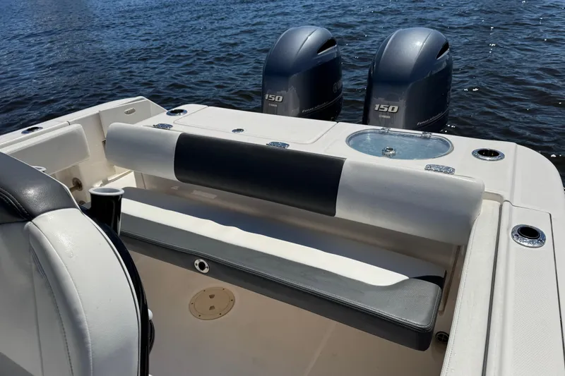 Slide: The Image of 2022 Robalo R242 Center Console boat with dual Yamaha 150 engines on water. - 19