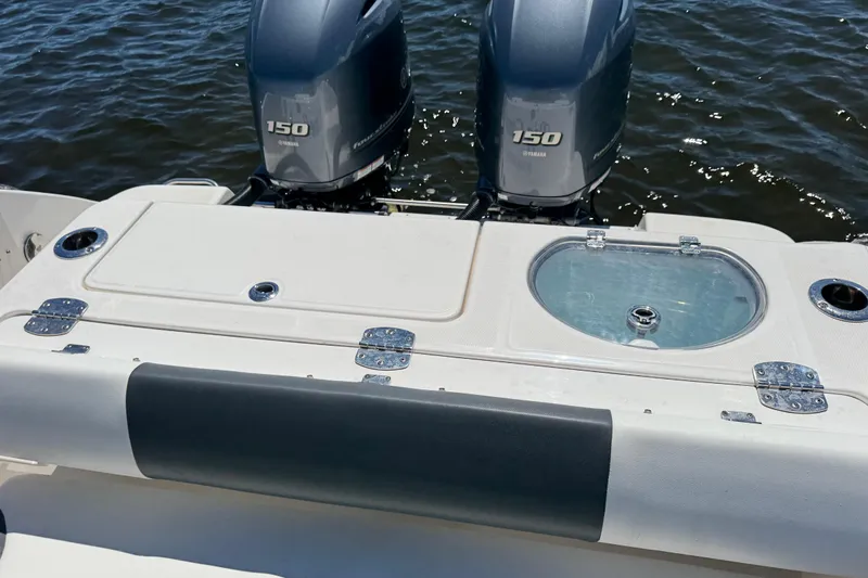 Slide: The Image of 2022 Robalo R242 Center Console boat with dual Yamaha 150 engines on water. - 20