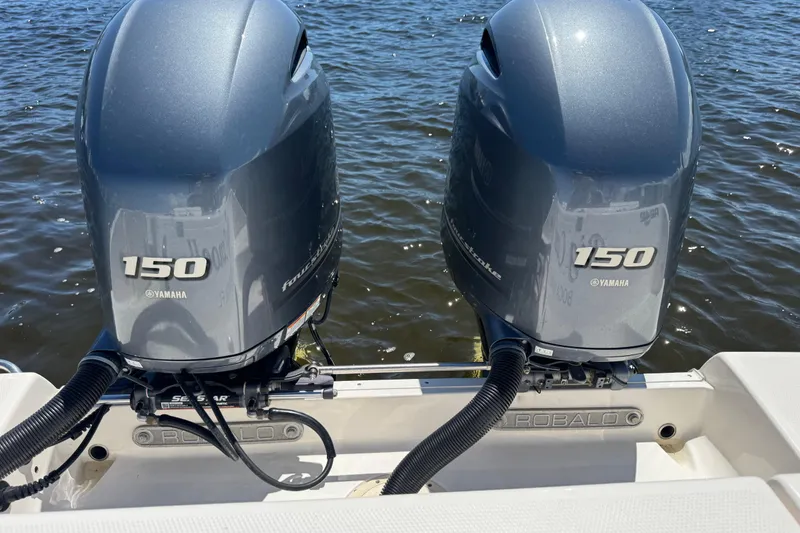 Slide: The Image of Twin Yamaha 150 engines on a 2022 Robalo R242 Center Console boat. - 23