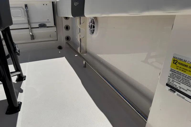 Slide: The Image of 2022 Robalo R242 Center Console interior, showcasing seating and capacity label for 12 persons. - 25