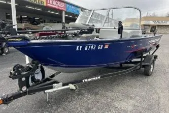 The Image of 2018 Tracker Pro Guide V-16 WT boat on trailer, parked outside dealership. - 4
