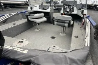 Slide: The Image of 2018 Tracker Pro Guide V-16 WT fishing boat interior with seating and steering console. - 6