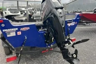 Slide: The Image of 2018 Tracker Pro Guide V-16 WT boat with outboard motor, parked on a trailer. - 7