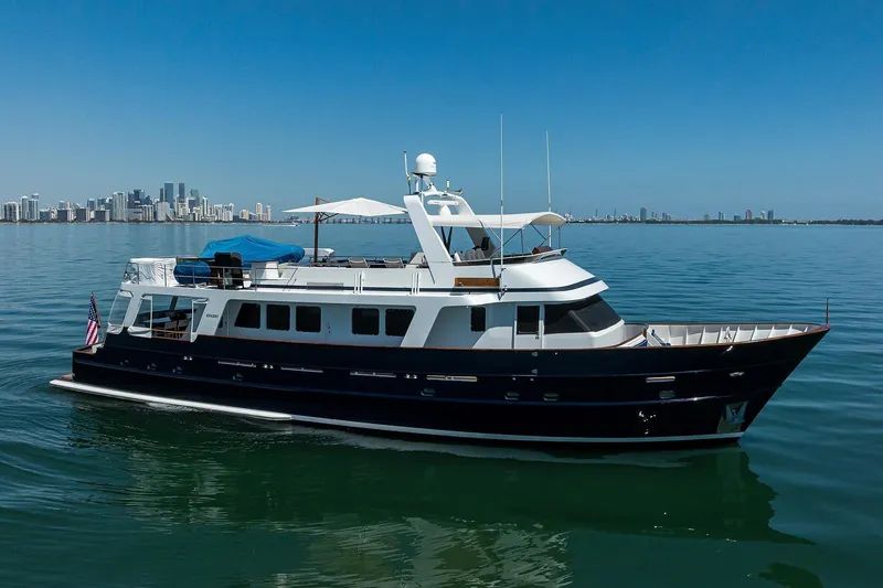 The Image of Elegant 1986 Jongert 85 yacht cruising near city skyline on calm waters. - 0