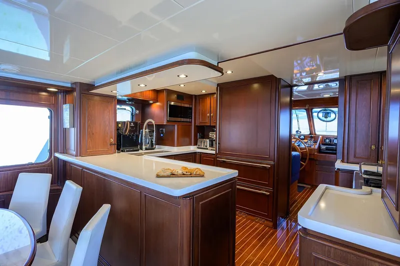 Slide: The Image of Luxurious 1986 Jongert 85 yacht interior with elegant wood finishes and modern kitchen amenities. - 14