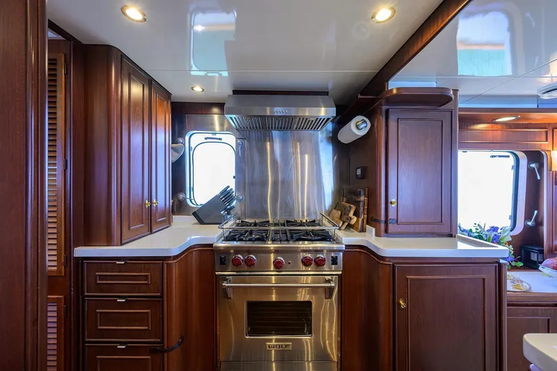 Slide: The Image of Luxurious 1986 Jongert 85 yacht kitchen with wooden cabinetry and modern appliances. - 15