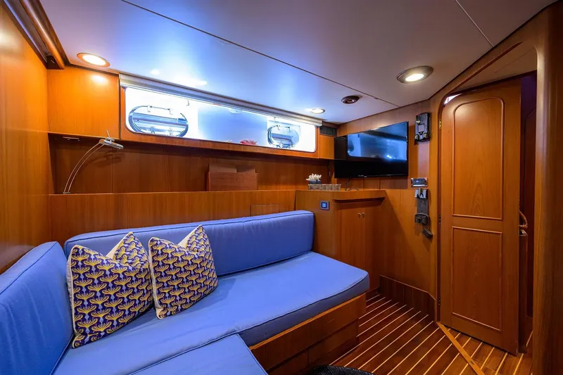 Slide: The Image of Luxurious 1986 Jongert 85 yacht interior with blue seating, wooden paneling, and modern amenities. - 20