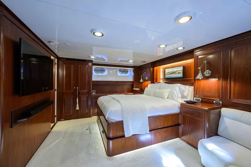 Slide: The Image of Luxurious cabin interior of 1986 Jongert 85 yacht with elegant wood paneling and cozy bedding. - 24