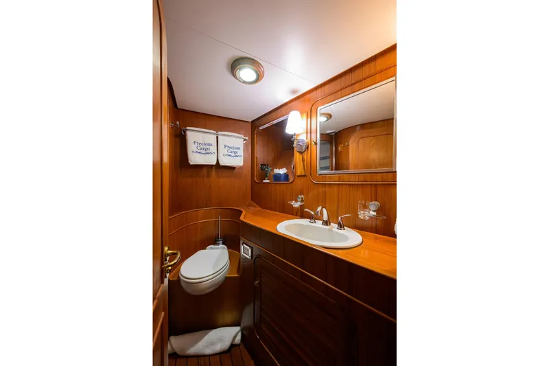 Slide: The Image of Luxurious wooden bathroom interior on 1986 Jongert 85 yacht, featuring sink and mirror. - 32