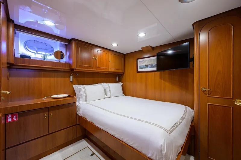 Slide: The Image of Luxurious cabin interior of 1986 Jongert 85 yacht with wood paneling and cozy bed. - 33