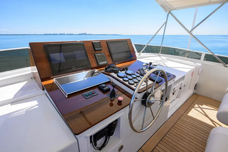 Slide: The Image of Helm of 1986 Jongert 85 yacht with modern navigation equipment and wooden steering wheel. - 4