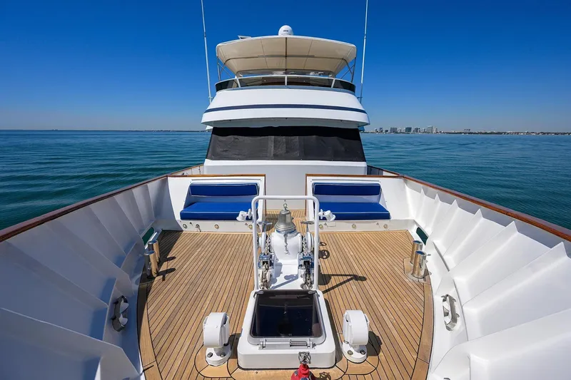 Slide: The Image of Luxurious 1986 Jongert 85 yacht deck with blue seating, cruising on calm waters. - 40