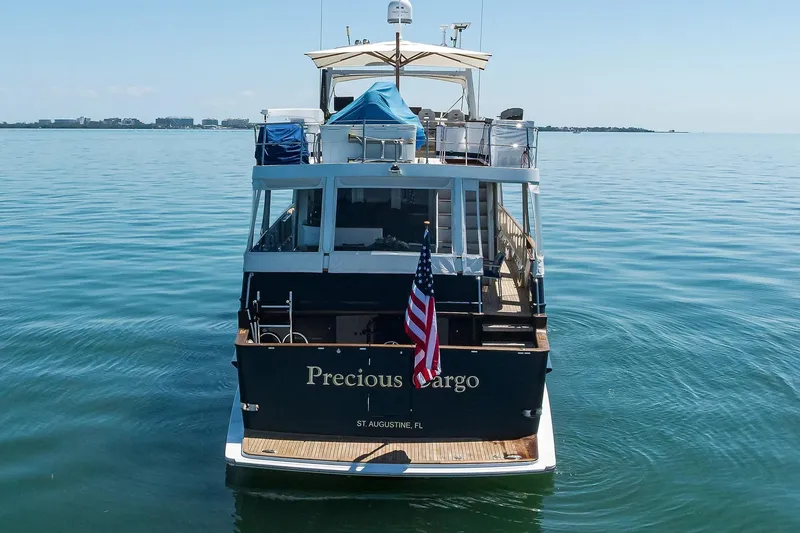 Slide: The Image of 1986 Jongert 85 yacht "Precious Cargo" on calm waters, rear view with American flag. - 41