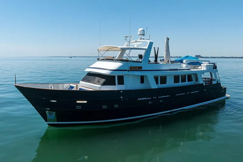Slide: The Image of 1986 Jongert 85 yacht on calm water under clear blue sky. - 42