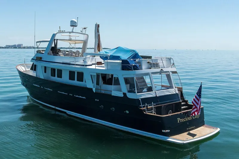 Slide: The Image of 1986 Jongert 85 yacht "Precious Cargo" on calm sea with American flag. - 43