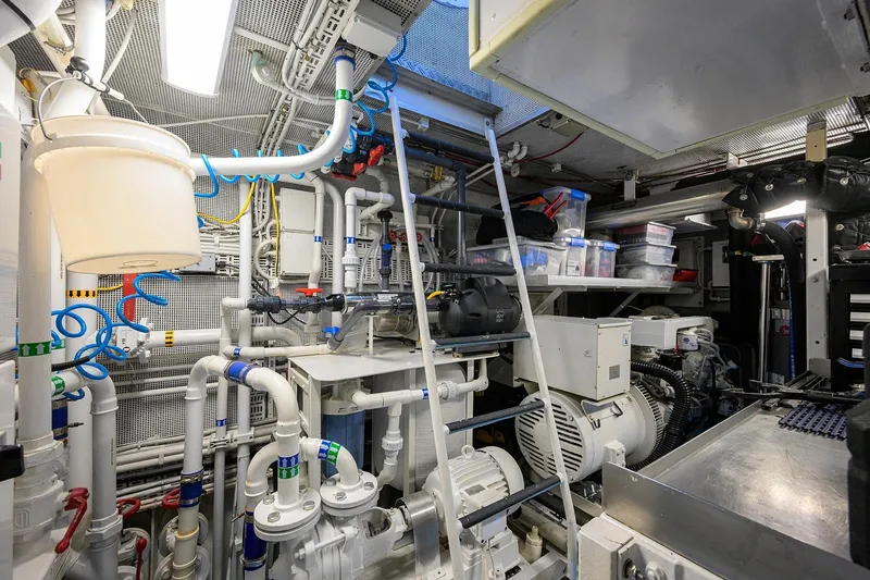 Slide: The Image of Engine room of a 1986 Jongert 85 yacht, featuring complex machinery and piping systems. - 47