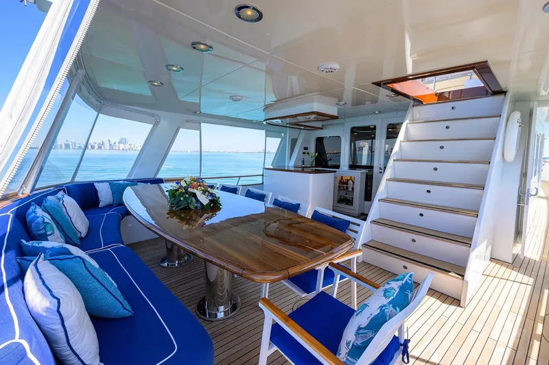 Slide: The Image of Luxurious 1986 Jongert 85 yacht interior with elegant seating, wooden table, and ocean view. - 6