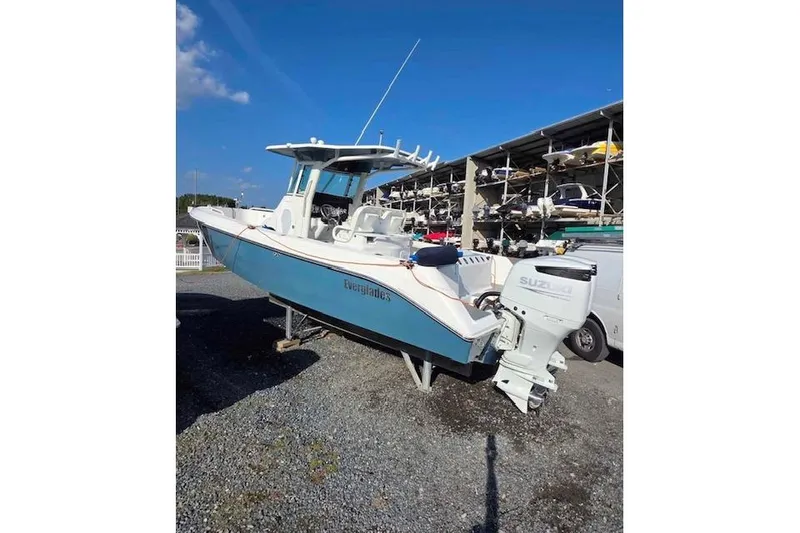 Slide: The Image of 2007 Everglades 260 Center Console boat with Suzuki outboard motor on gravel. - 2