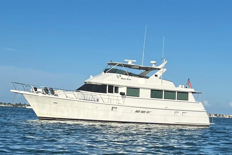 The Image of 1997 Hatteras 70 Sport Deck Motor Yacht on calm blue waters. - 0