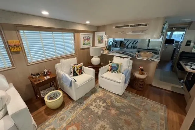 Slide: The Image of Luxurious interior of a 1997 Hatteras 70 Sport Deck Motor Yacht with elegant seating and decor. - 11