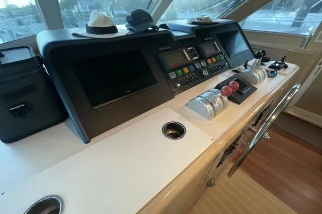 Slide: The Image of Helm of 1997 Hatteras 70 Sport Deck Motor Yacht with navigation controls and displays. - 13