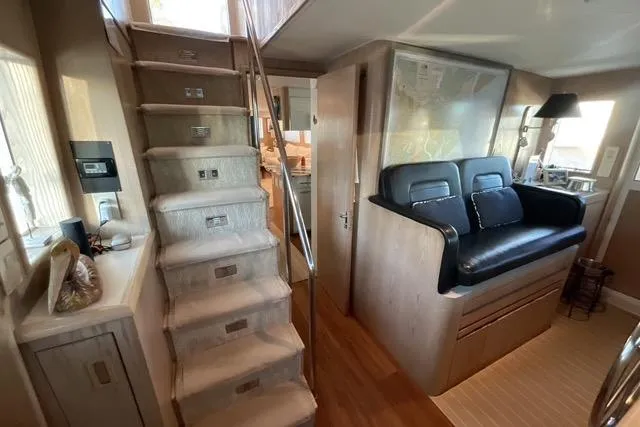 Slide: The Image of Interior of 1997 Hatteras 70 Sport Deck Motor Yacht with stairs and seating area. - 17