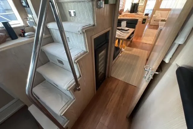 Slide: The Image of Interior of 1997 Hatteras 70 Sport Deck Motor Yacht with stairs and modern decor. - 18