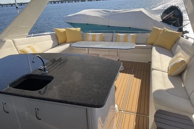 Slide: The Image of Luxurious 1997 Hatteras 70 Sport Deck Motor Yacht with elegant seating and modern amenities. - 24