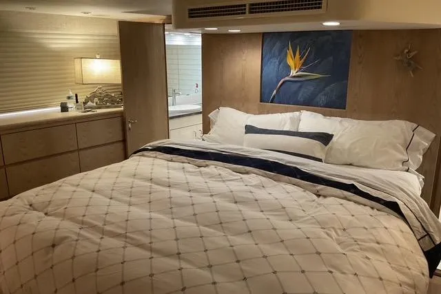 Slide: The Image of Luxurious bedroom in 1997 Hatteras 70 Sport Deck Motor Yacht with elegant decor. - 27