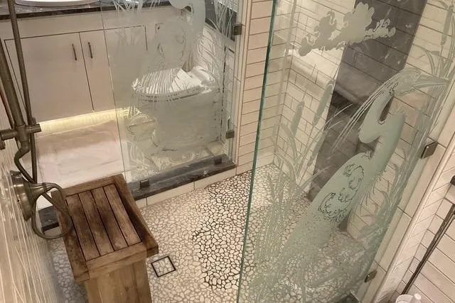 Slide: The Image of Luxurious bathroom on 1997 Hatteras 70 Sport Deck Motor Yacht with etched glass and wooden accents. - 28