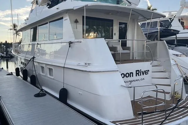 Slide: The Image of 1997 Hatteras 70 Sport Deck Motor Yacht docked at marina, rear view. - 3