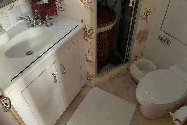 Slide: The Image of Bathroom interior of 1997 Hatteras 70 Sport Deck Motor Yacht with sink and toilet. - 30