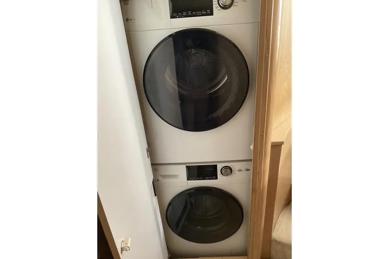 Slide: The Image of Stacked washer and dryer inside 1997 Hatteras 70 Sport Deck Motor Yacht. - 31