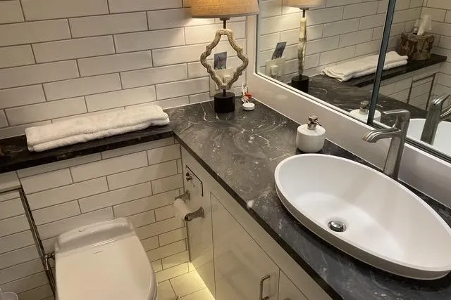 Slide: The Image of Luxurious bathroom in 1997 Hatteras 70 Sport Deck Motor Yacht with modern sink and elegant decor. - 33