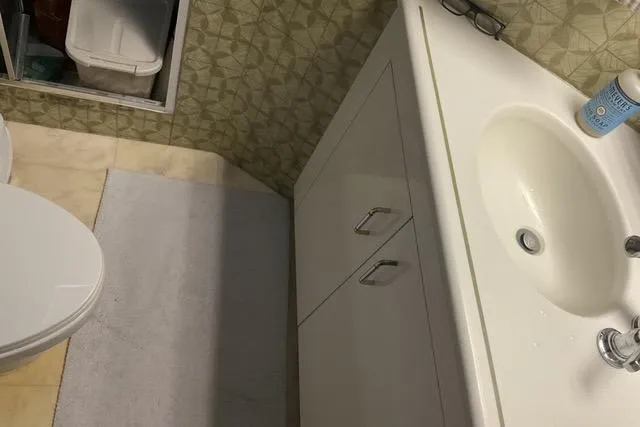 Slide: The Image of Bathroom interior of 1997 Hatteras 70 Sport Deck Motor Yacht with sink and toilet. - 38