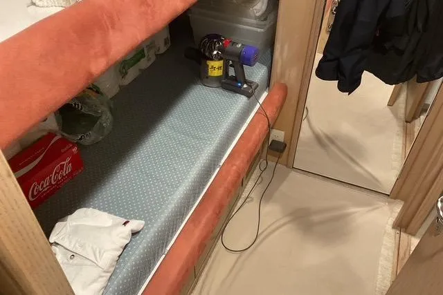 Slide: The Image of Interior of 1997 Hatteras 70 Sport Deck Motor Yacht with storage and cleaning supplies. - 39