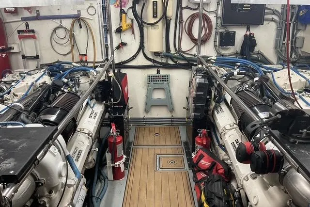 Slide: The Image of Engine room of 1997 Hatteras 70 Sport Deck Motor Yacht, featuring dual engines and equipment. - 40