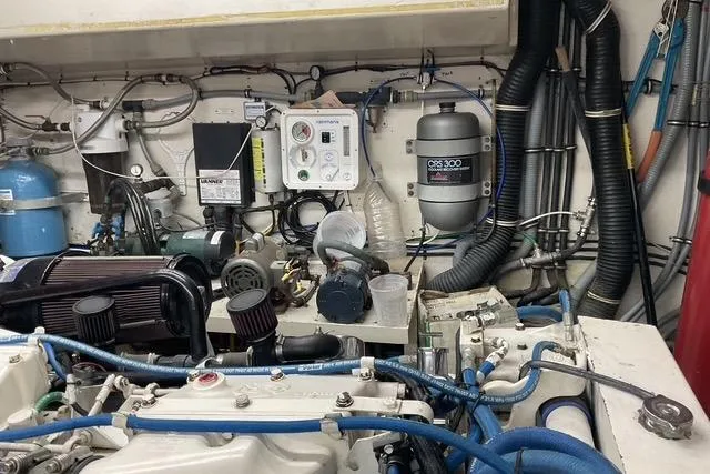 Slide: The Image of Engine room of 1997 Hatteras 70 Sport Deck Motor Yacht with complex machinery and wiring. - 45