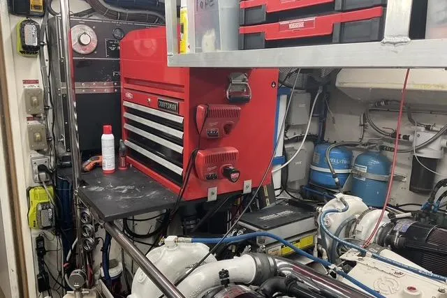 Slide: The Image of Engine room of 1997 Hatteras 70 Sport Deck Motor Yacht with tools and equipment. - 46