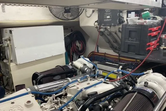 Slide: The Image of Engine room of a 1997 Hatteras 70 Sport Deck Motor Yacht, showcasing mechanical components. - 47