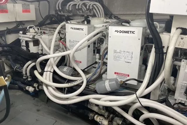 Slide: The Image of Engine room of 1997 Hatteras 70 Sport Deck Motor Yacht with Dometic systems and complex piping. - 53