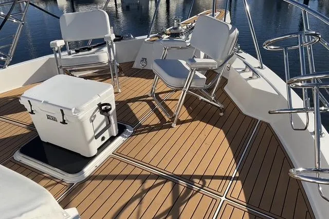 Slide: The Image of 1997 Hatteras 70 Sport Deck Motor Yacht with teak deck and seating area. - 58