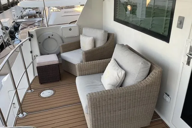 Slide: The Image of Cozy seating area on 1997 Hatteras 70 Sport Deck Motor Yacht with wicker chairs and cushions. - 7