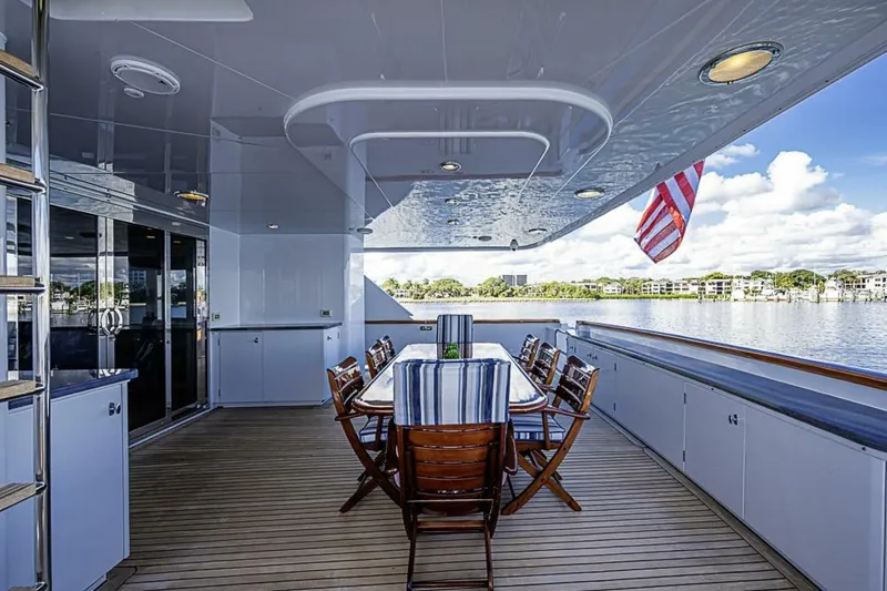 Slide: The Image of Luxurious deck of 1997 Delta 122 Tri-Deck Motor Yacht with dining area and scenic water view. - 14