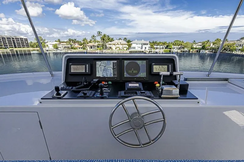 Slide: The Image of Helm of 1997 Delta 122 Tri-Deck Motor Yacht with navigation equipment and waterfront view. - 22
