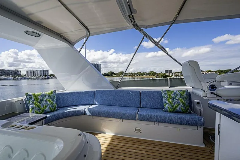 Slide: The Image of Luxurious seating area on 1997 Delta 122 Tri-Deck Motor Yacht with scenic waterfront view. - 24