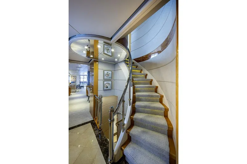 Slide: The Image of Luxurious spiral staircase inside 1997 Delta 122 Tri-Deck Motor Yacht, featuring elegant design. - 36